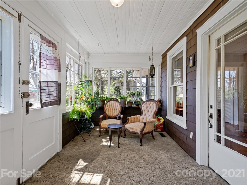 604 Fairview Road Asheville, NC 28803 - Photo 2 of 18 a outdoor room with couple of furniture and a window