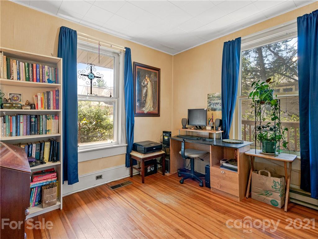 604 Fairview Road Asheville, NC 28803 - Photo 4 of 18 a view of a workspace with furniture and a large window