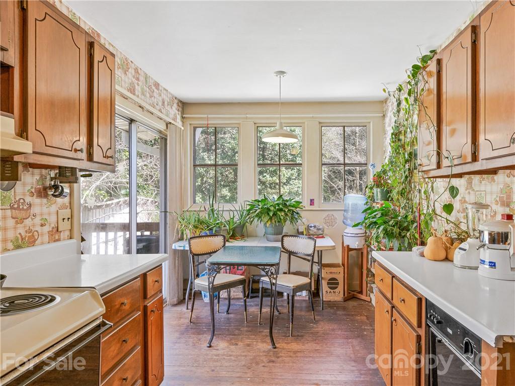 604 Fairview Road Asheville, NC 28803 - Photo 6 of 18 a view of a dining room with furniture window and wooden floor