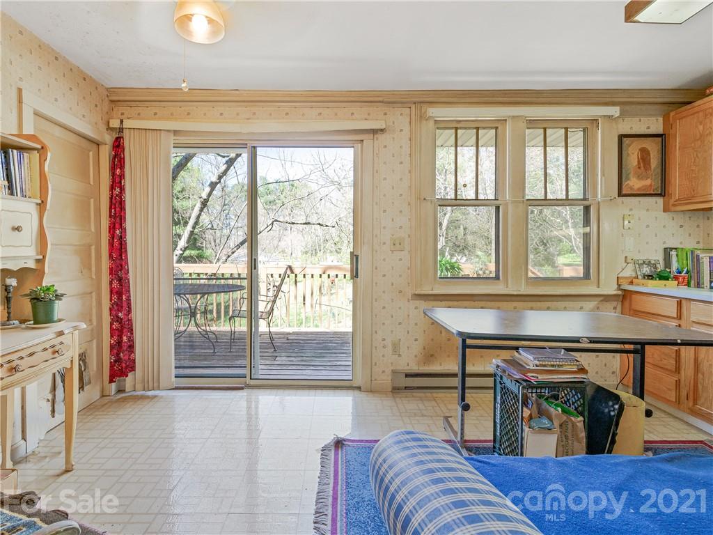 604 Fairview Road Asheville, NC 28803 - Photo 8 of 18 a living room with furniture and a floor to ceiling window