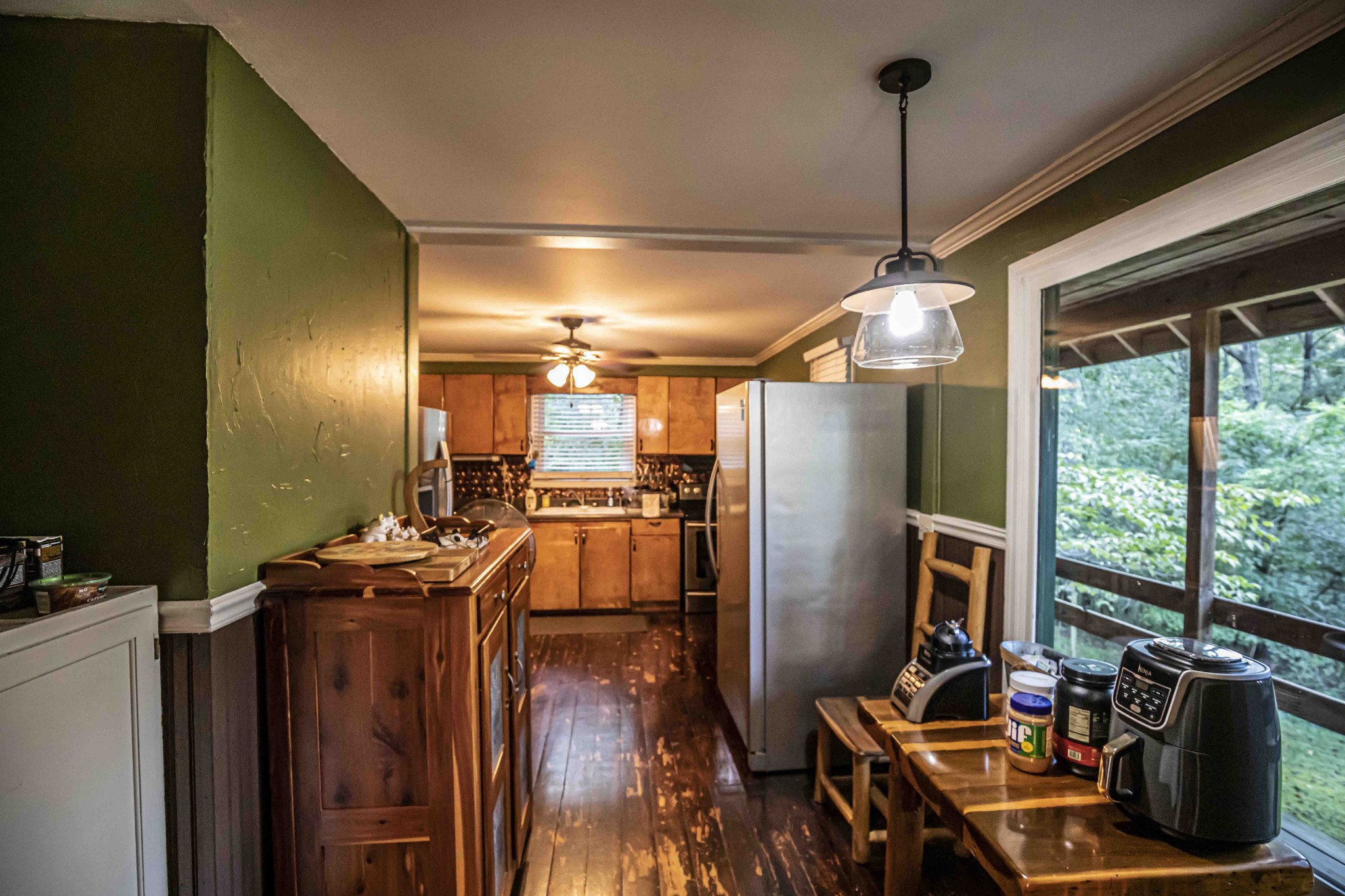 8781 Richards Road Lyles, TN 37098 - Photo 24 of 50 a kitchen with stainless steel appliances kitchen island granite countertop a refrigerator a stove and a sink with wooden floor