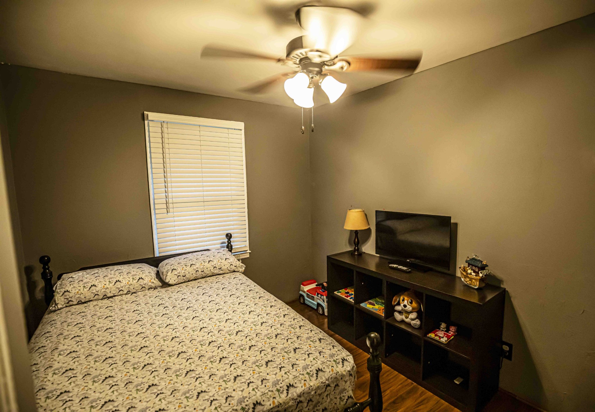 8781 Richards Road Lyles, TN 37098 - Photo 27 of 50 a bedroom with a bed and a flat tv screen on a dresser
