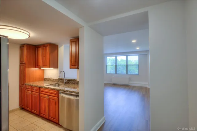 a kitchen with stainless steel appliances granite countertop a stove and a sink