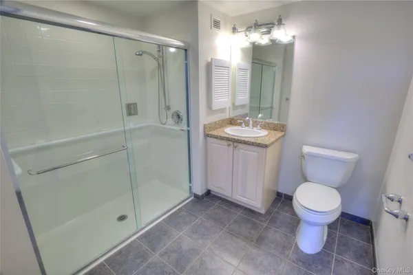 a bathroom with a toilet a sink and shower