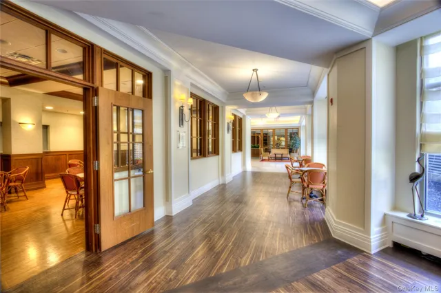 a view of a hallway with wooden floor fireplace and dining room