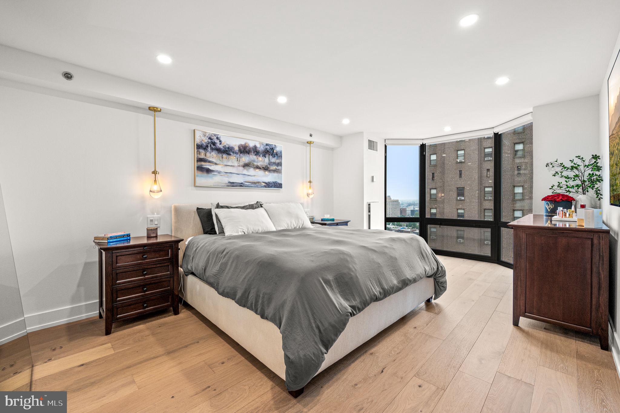 2020 Walnut Street, Unit 19LM Philadelphia, PA 19103 - Photo 16 of 60 a spacious bedroom with a bed and a dresser