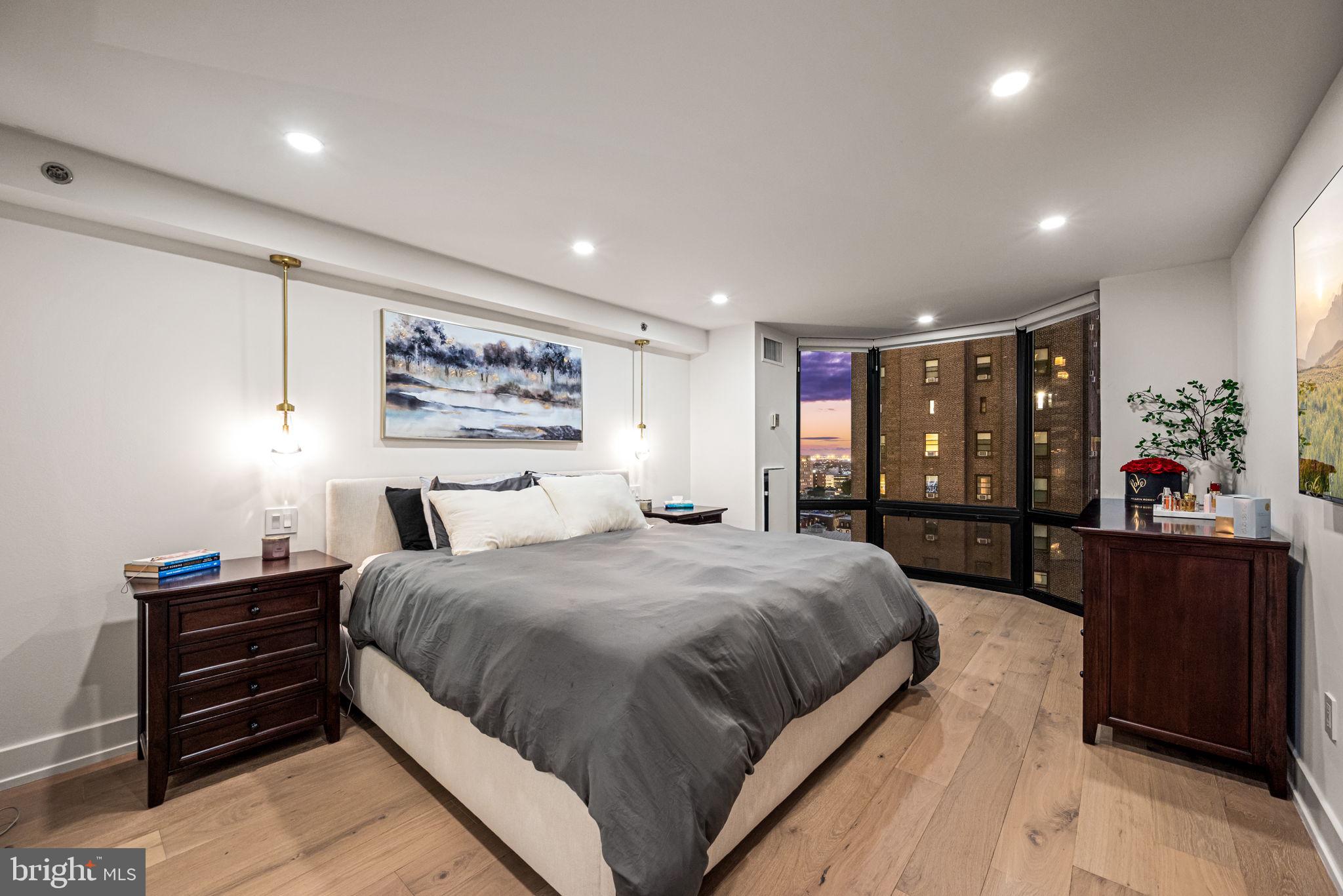 2020 Walnut Street, Unit 19LM Philadelphia, PA 19103 - Photo 17 of 60 a bedroom with a large bed and a dresser