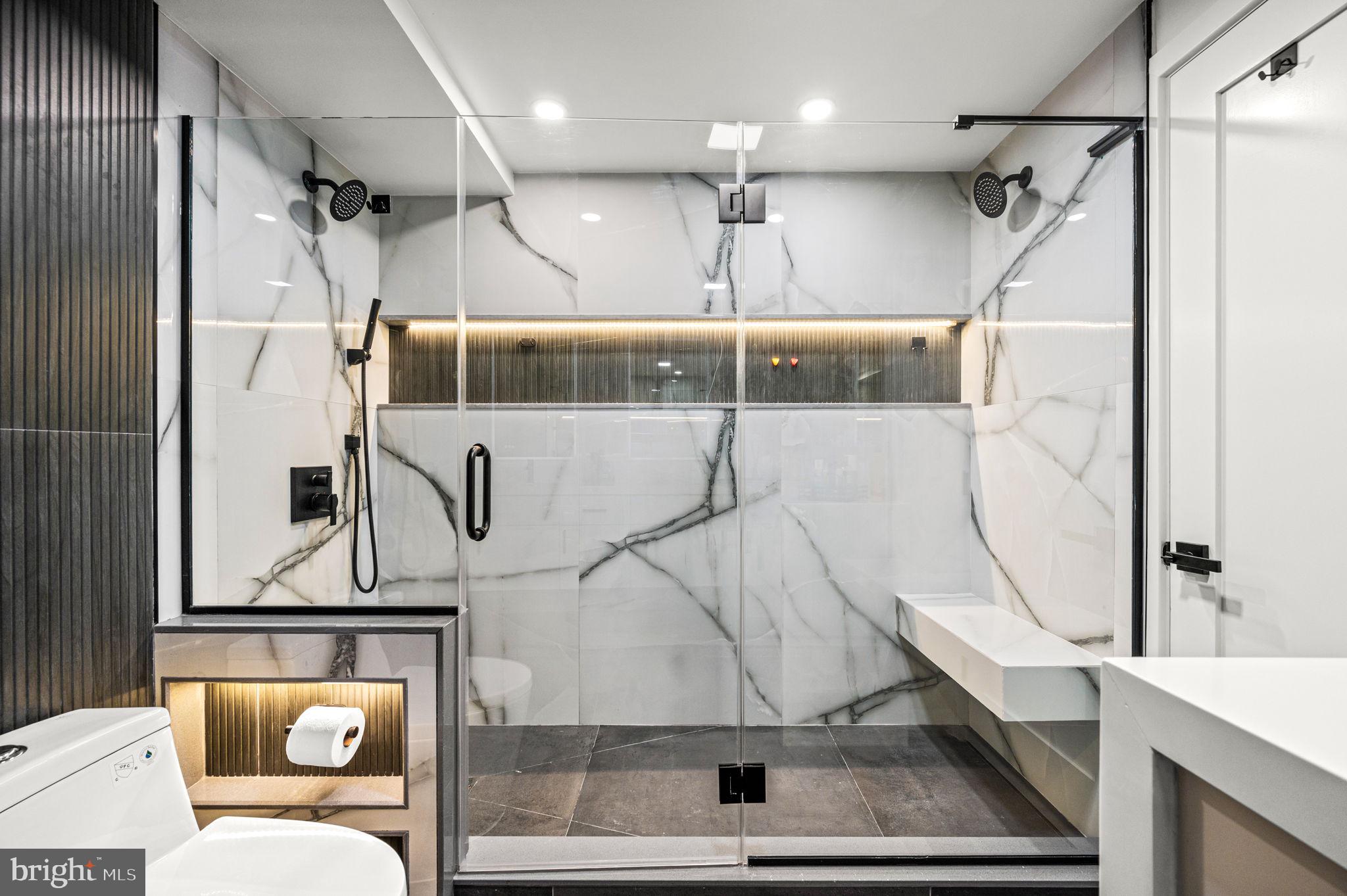 2020 Walnut Street, Unit 19LM Philadelphia, PA 19103 - Photo 19 of 60 a bathroom with a sink a mirror and a shower