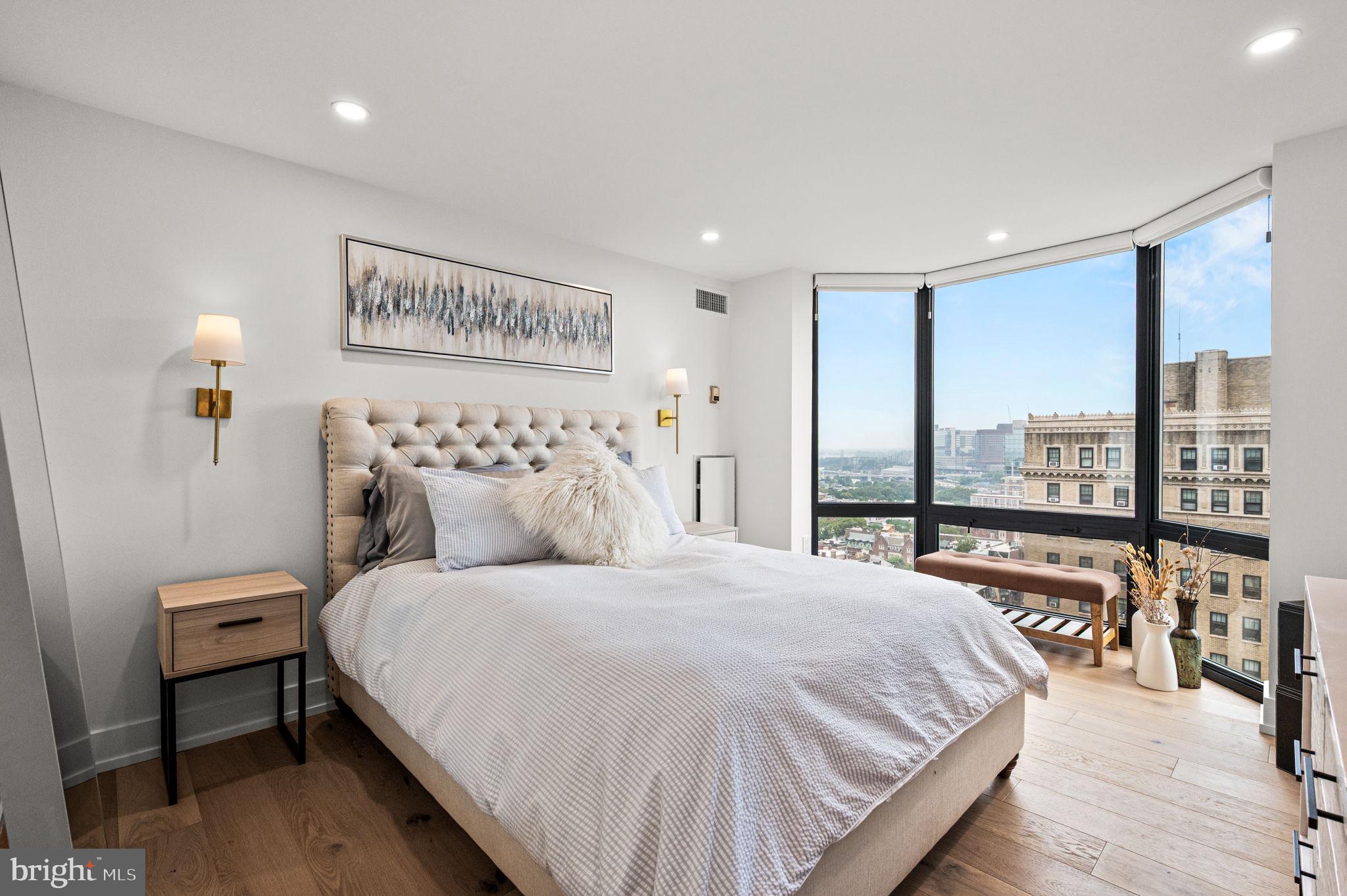 2020 Walnut Street, Unit 19LM Philadelphia, PA 19103 - Photo 24 of 60 a bedroom with a large bed and a large window