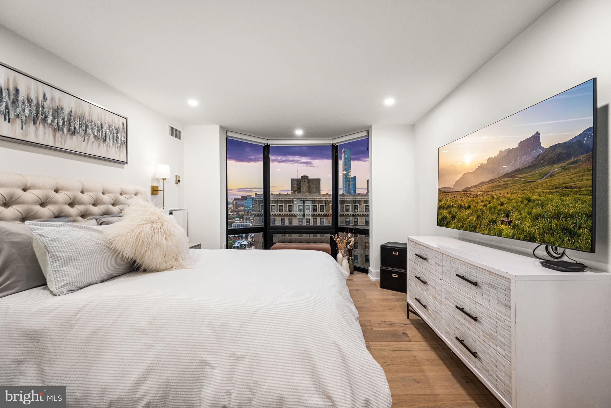 2020 Walnut Street, Unit 19LM Philadelphia, PA 19103 - Photo 25 of 60 a large bedroom with a bed and a flat tv screen on dresser
