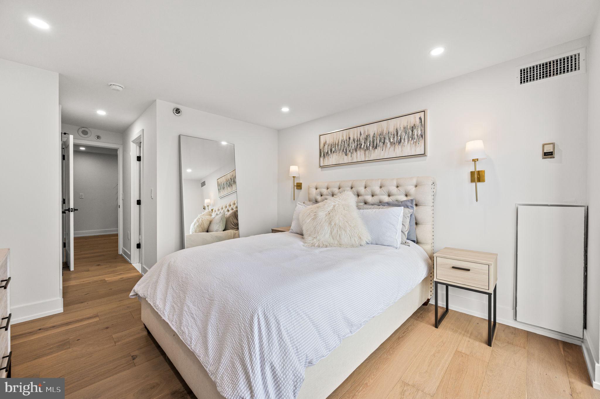 2020 Walnut Street, Unit 19LM Philadelphia, PA 19103 - Photo 28 of 60 a spacious bedroom with a bed and a painting