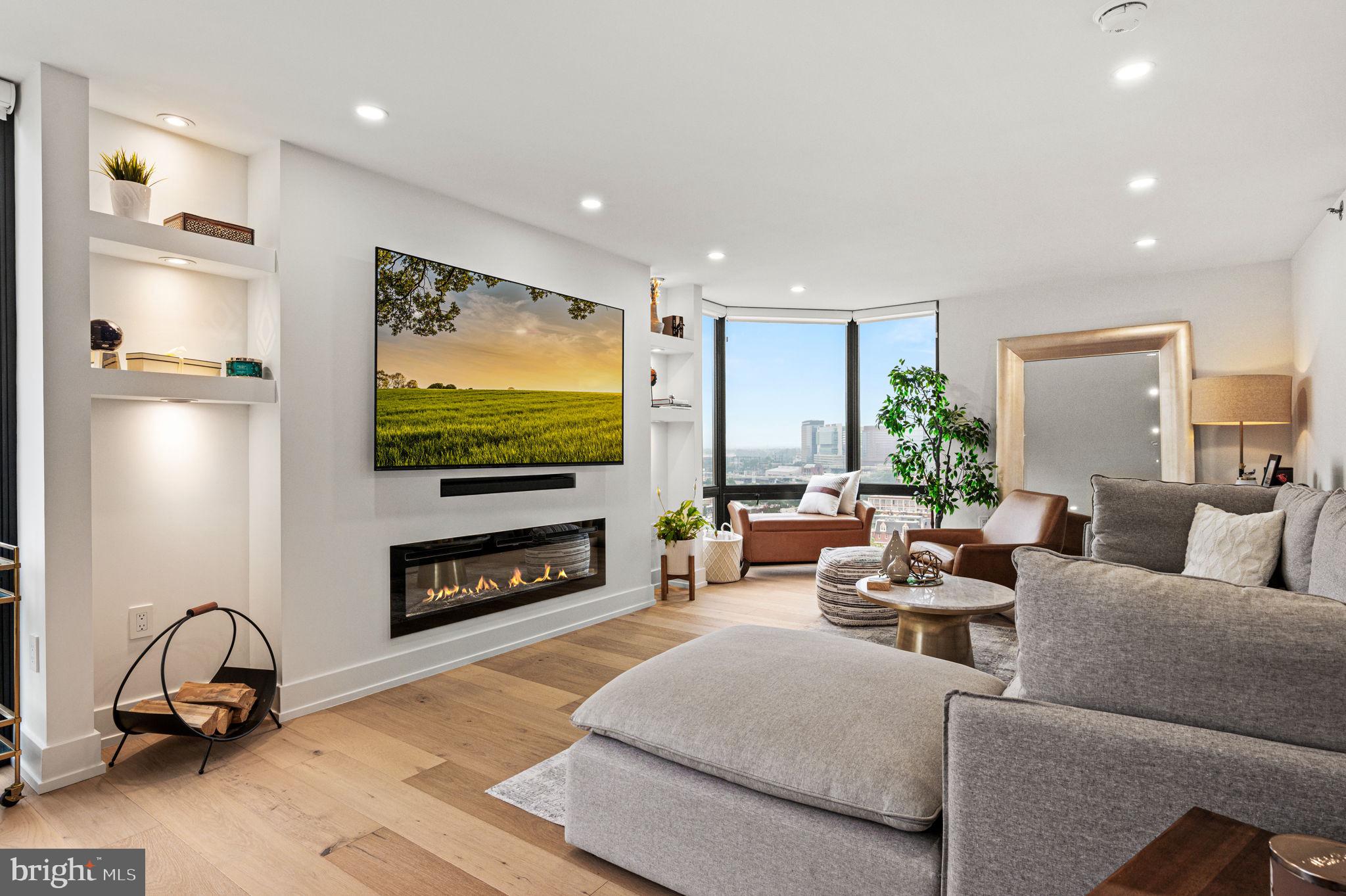 2020 Walnut Street, Unit 19LM Philadelphia, PA 19103 - Photo 3 of 60 a living room with furniture a flat screen tv and a fireplace