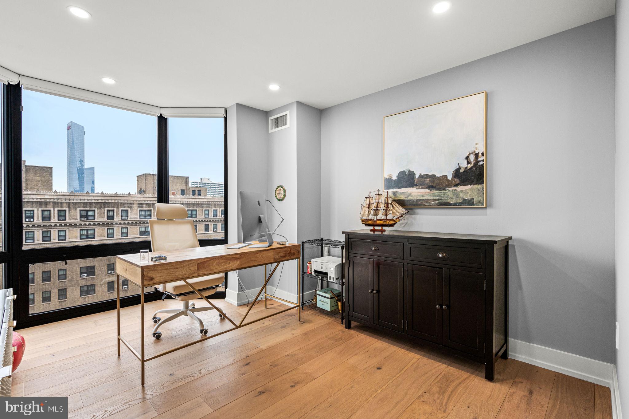 2020 Walnut Street, Unit 19LM Philadelphia, PA 19103 - Photo 32 of 60 a living room with furniture and wooden floor