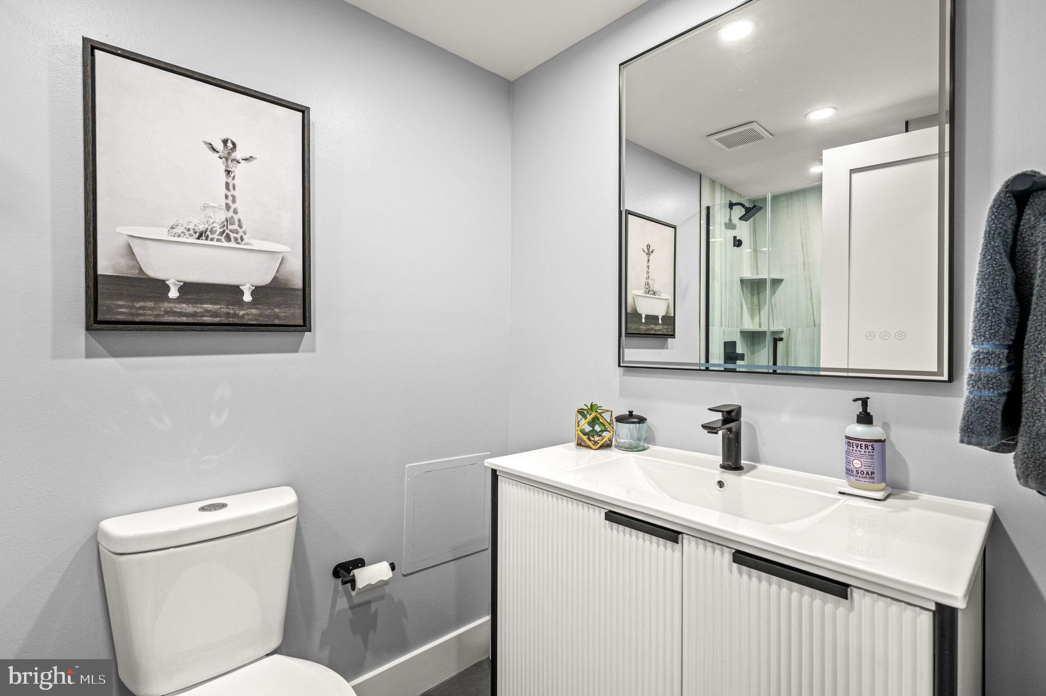 2020 Walnut Street, Unit 19LM Philadelphia, PA 19103 - Photo 35 of 60 a bathroom with a toilet sink and mirror