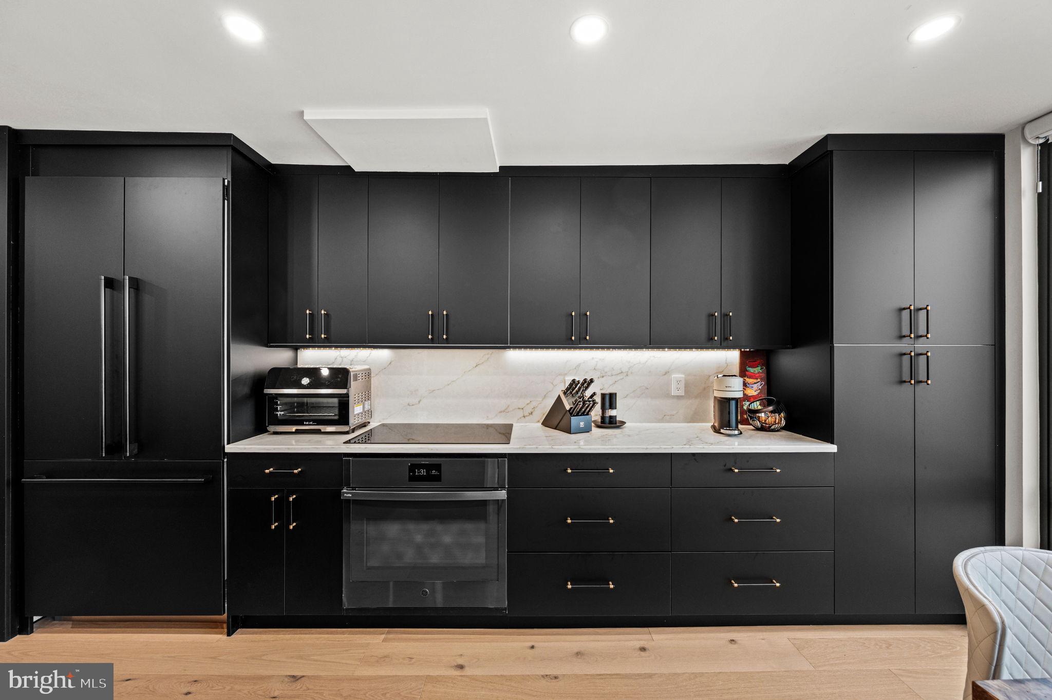 2020 Walnut Street, Unit 19LM Philadelphia, PA 19103 - Photo 7 of 60 a kitchen with a stove and a refrigerator