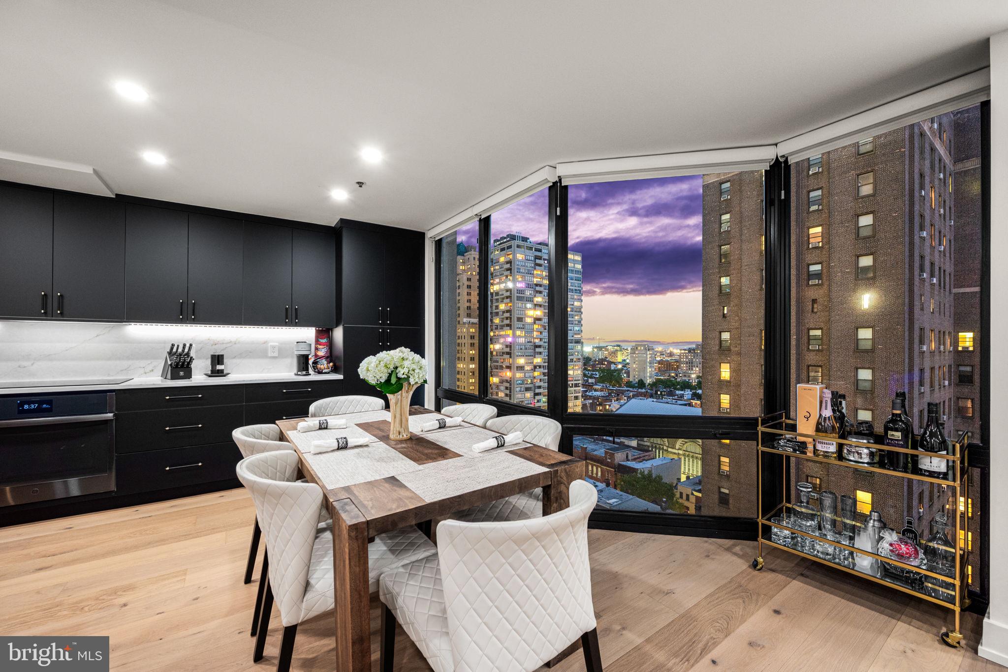 2020 Walnut Street, Unit 19LM Philadelphia, PA 19103 - Photo 10 of 60 a living room with furniture a floor to ceiling window and furniture