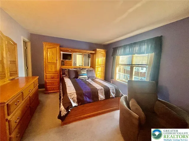 a living room with a bed furniture and a window