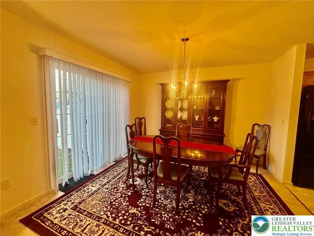 a view of a dining room with furniture and window