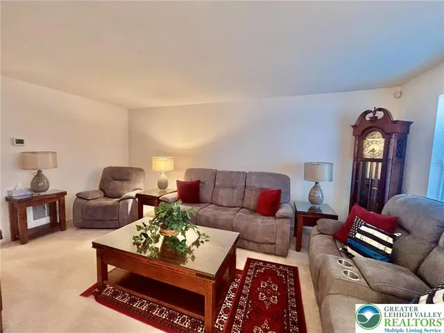 a living room with furniture and a mirror