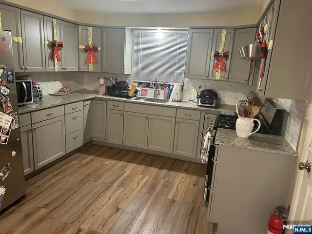 a kitchen with a sink cabinets and window