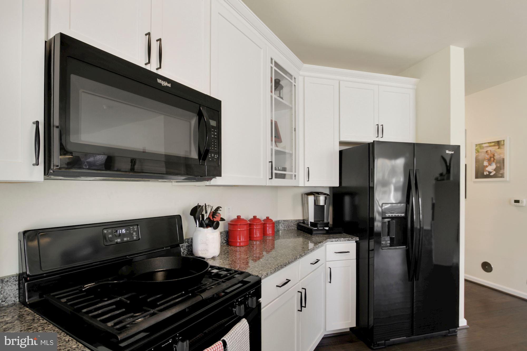 3825 Doc Berlin Drive, Unit 17 Silver Spring, MD 20906 - Photo 5 of 34 a kitchen with stainless steel appliances a stove a microwave a sink and cabinets