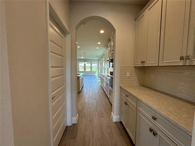 a view of hallway with wooden floor