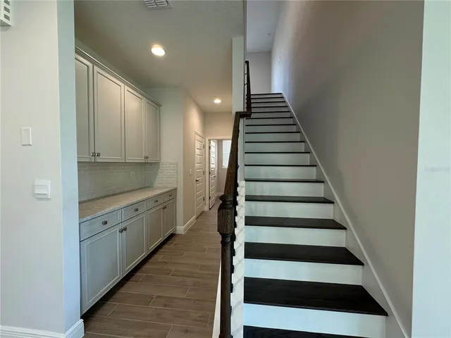 a view of entryway and hall with wooden floor
