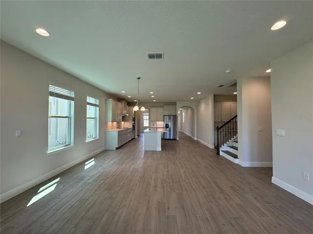 a living room with a couch and wooden floor