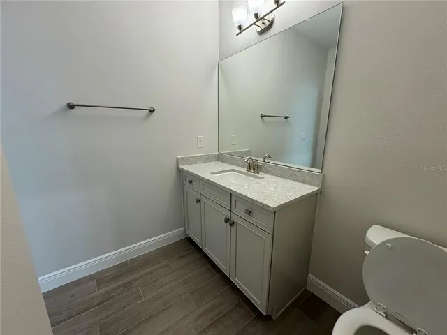 a bathroom with a sink toilet and vanity