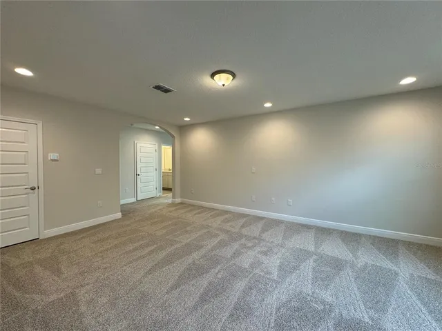 an empty room with window and pillar in it