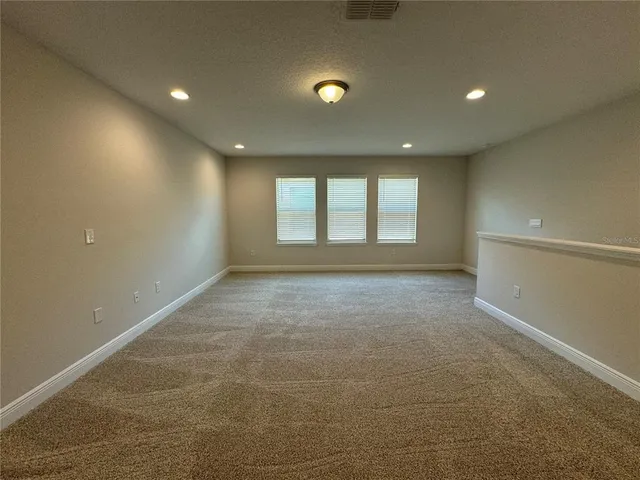an empty room with a exposed radiator and window
