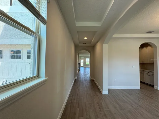a view of hallway with wooden floor