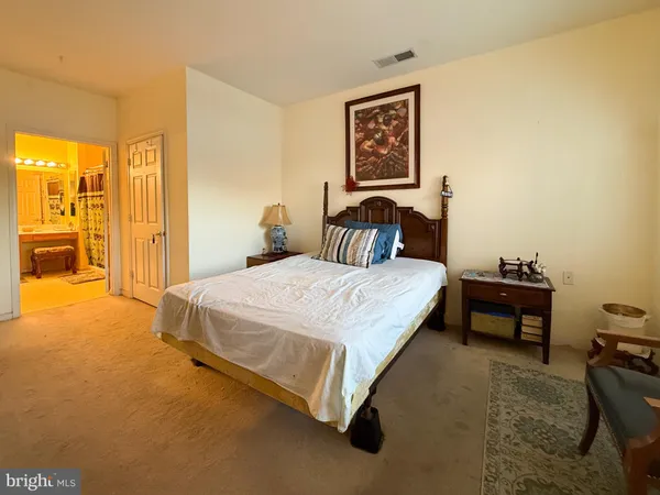 a bedroom with a bed and dresser