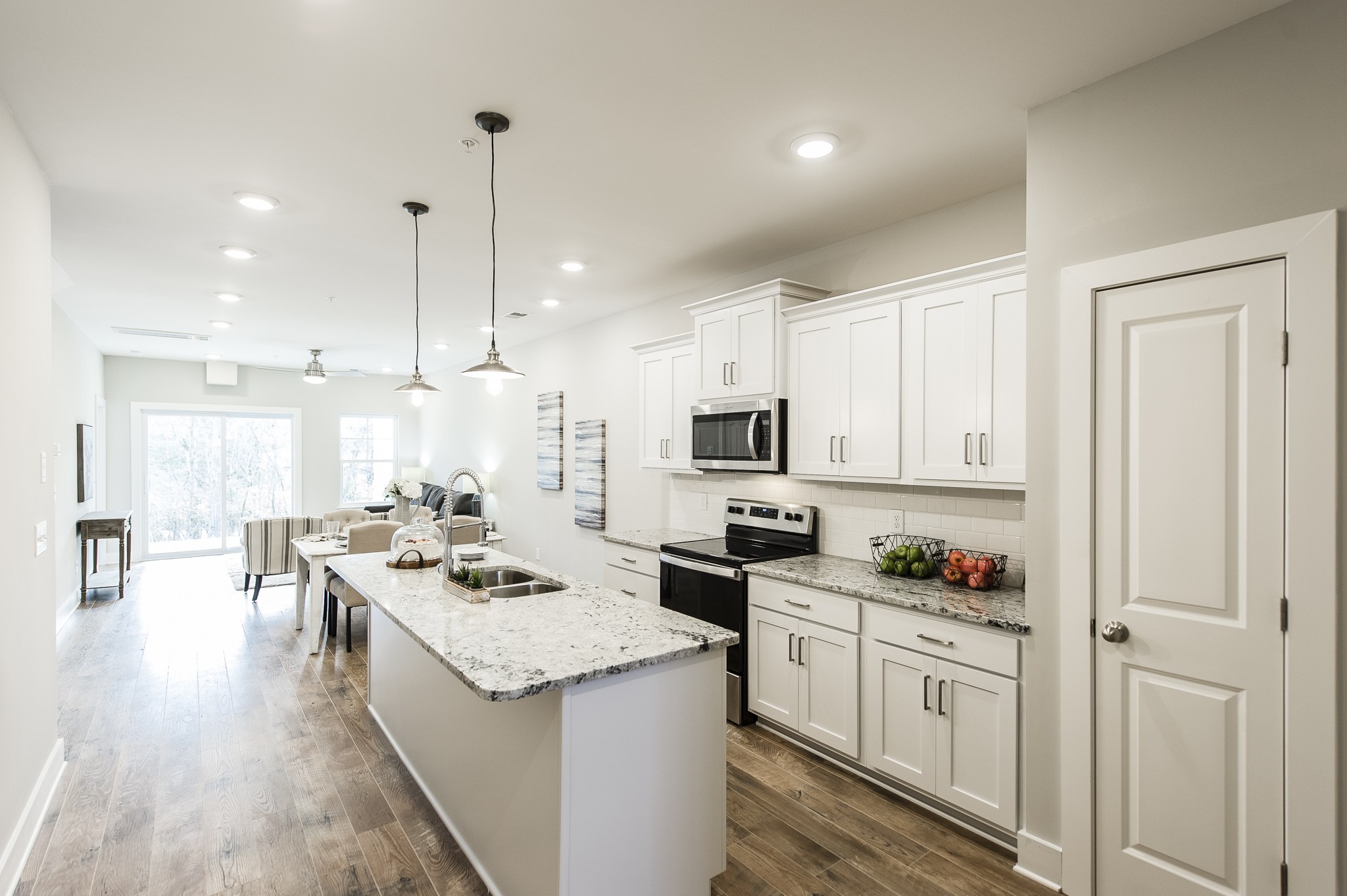 1144 Lock 4 Road, Unit B5 Gallatin, TN 37066 - Photo 8 of 24 The bright white kitchen is a dream, complete with granite countertops, a stylish tile backsplash,