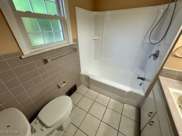 15959 Glynn Road Cleveland, OH 44112 - Photo 22 of 23 Full bath with tile walls, shower / washtub combination, vanity, wainscoting, and light tile patterned flooring