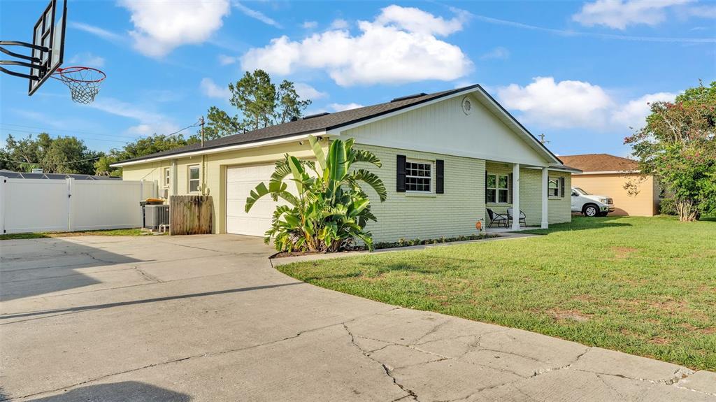 a front view of house with yard and trees around