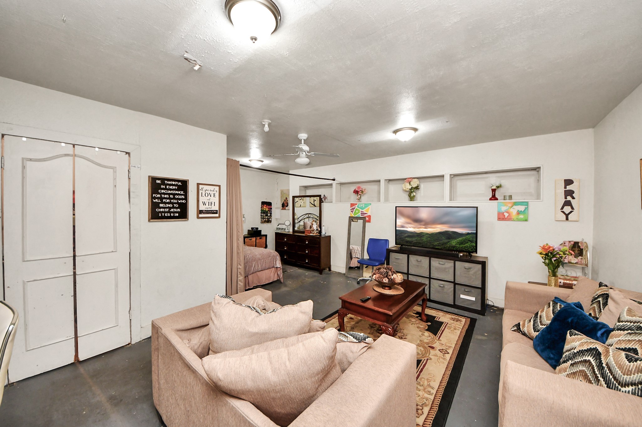 4155 Amir Street Houston, TX 77072 - Photo 26 of 43 a living room with furniture a flat screen tv and a refrigerator