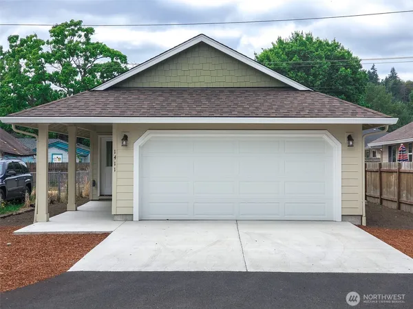 a view of small house with garage