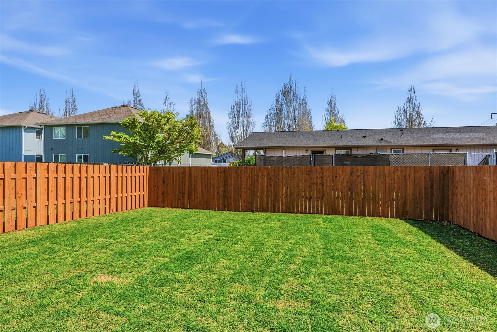 204 Douglas Street Longview, WA 98632 - Photo 12 of 31 a view of a backyard with potted plants and wooden fence