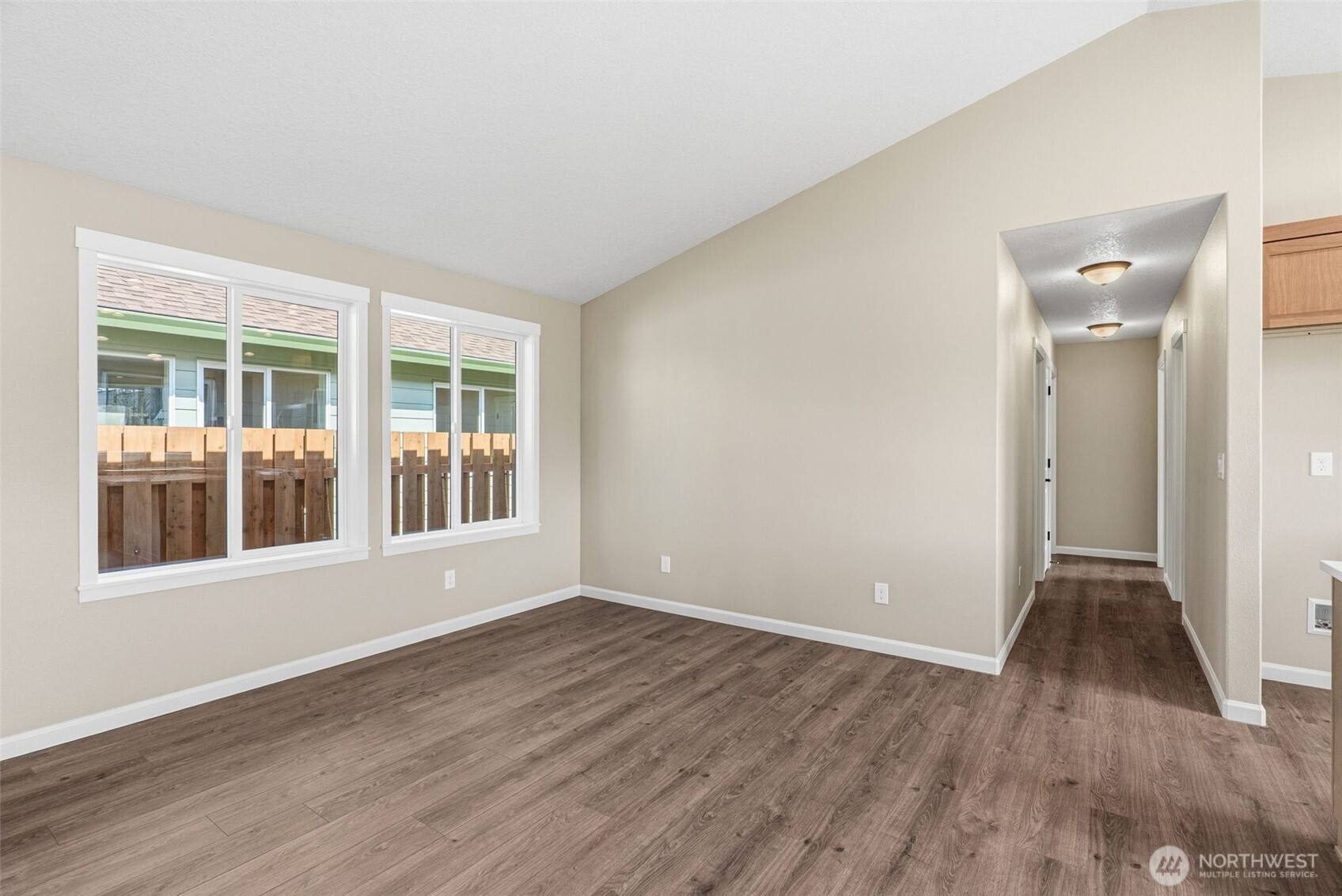 204 Douglas Street Longview, WA 98632 - Photo 16 of 31 a view of an empty room with wooden floor and a window