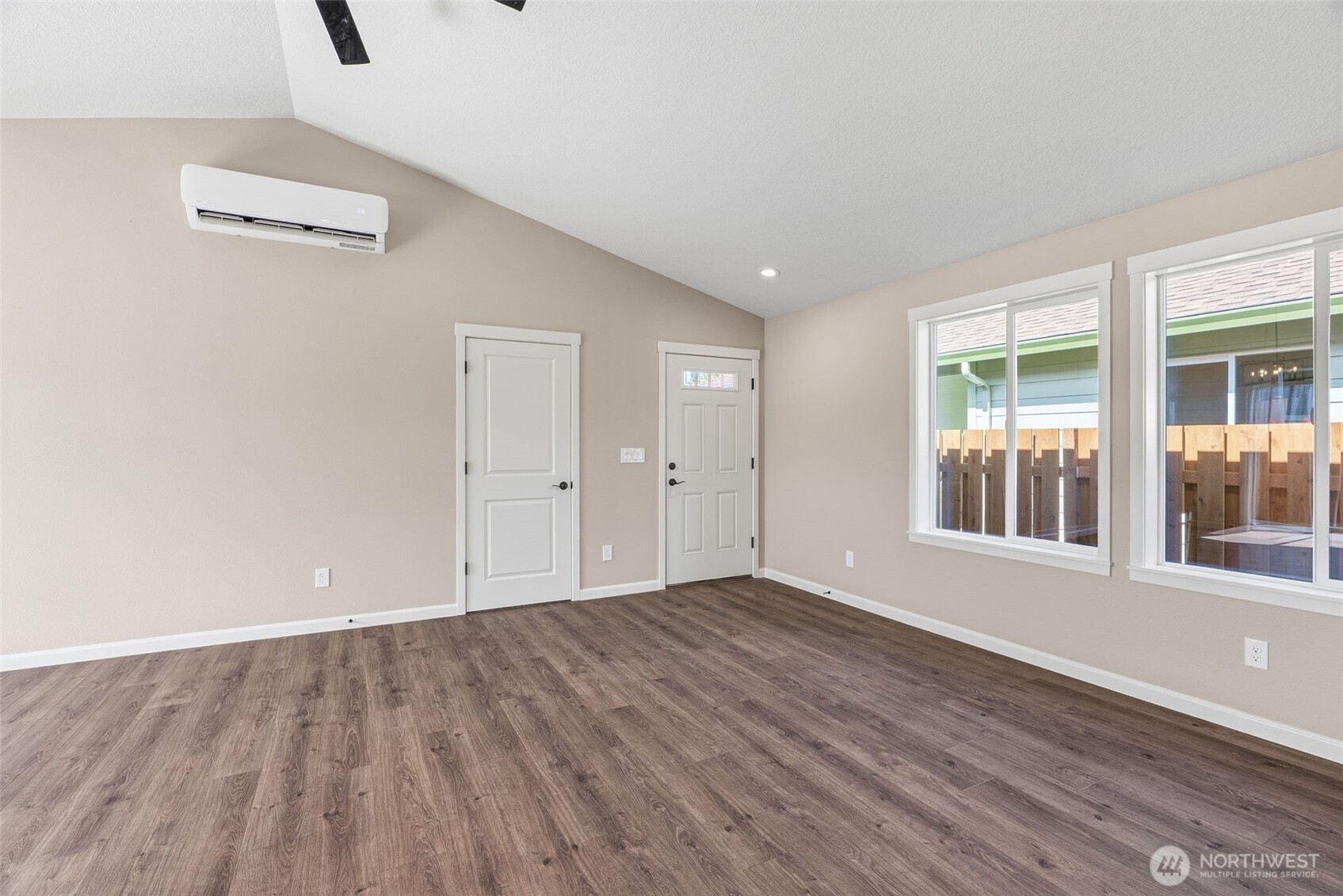 204 Douglas Street Longview, WA 98632 - Photo 17 of 31 a view of an empty room with wooden floor and windows