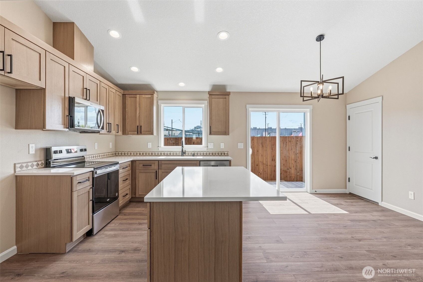 204 Douglas Street Longview, WA 98632 - Photo 18 of 31 a large kitchen with stainless steel appliances granite countertop a stove and cabinets