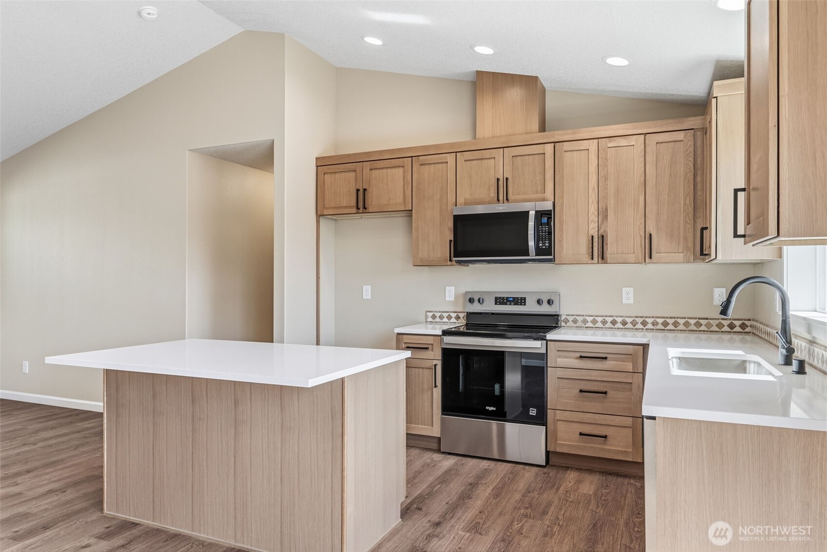 204 Douglas Street Longview, WA 98632 - Photo 21 of 31 a kitchen with stainless steel appliances granite countertop a stove top oven a sink dishwasher and a refrigerator with wooden floor