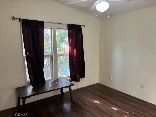 a room with wooden floor and windows