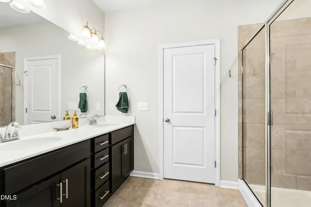 a bathroom with a double vanity sink mirror and