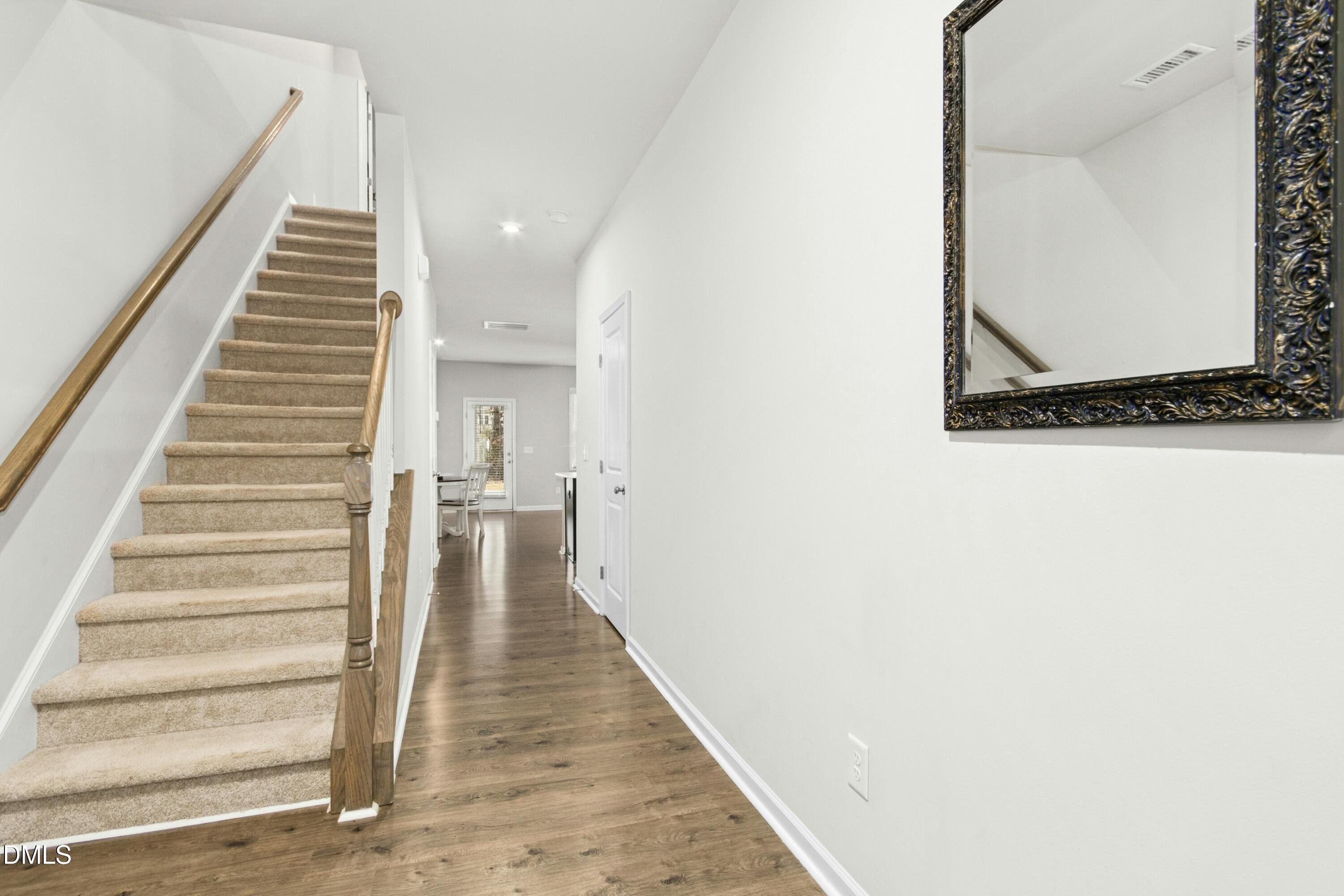 3645 Water Mist Lane Raleigh, NC 27604 - Photo 2 of 29 a view of a hallway with wooden floor and staircase