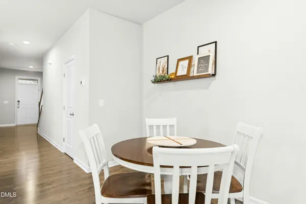 a dining room with furniture and wooden floor