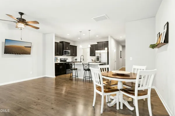a view of a dining room with furniture and wooden floor