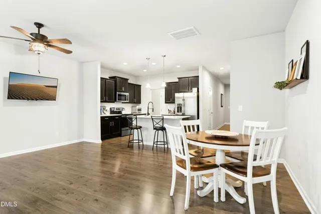 a view of a dining room with furniture and wooden floor