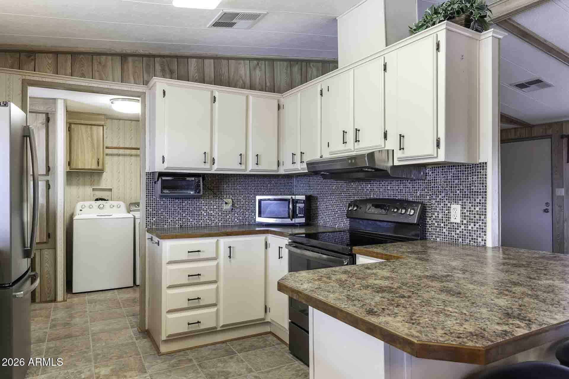 2100 North Trekell Road, Unit 143 Casa Grande, AZ 85122 - Photo 17 of 34 a kitchen with stainless steel appliances granite countertop a stove a sink and a refrigerator